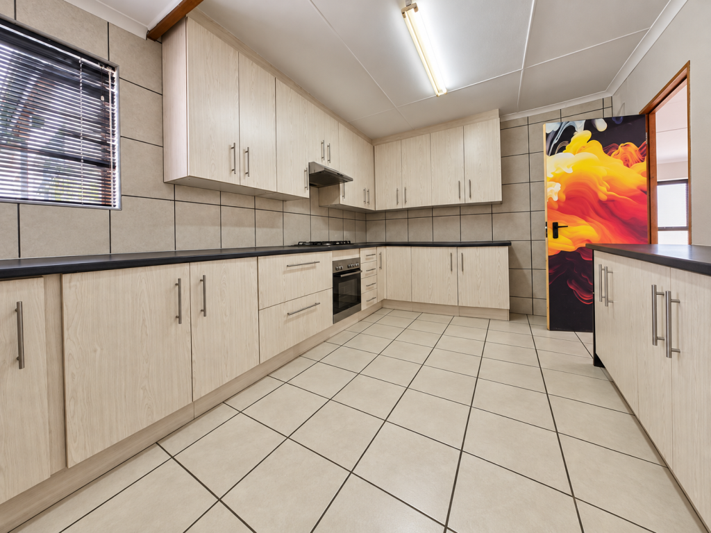 Bright Minimalist Kitchen with Vibrant Door