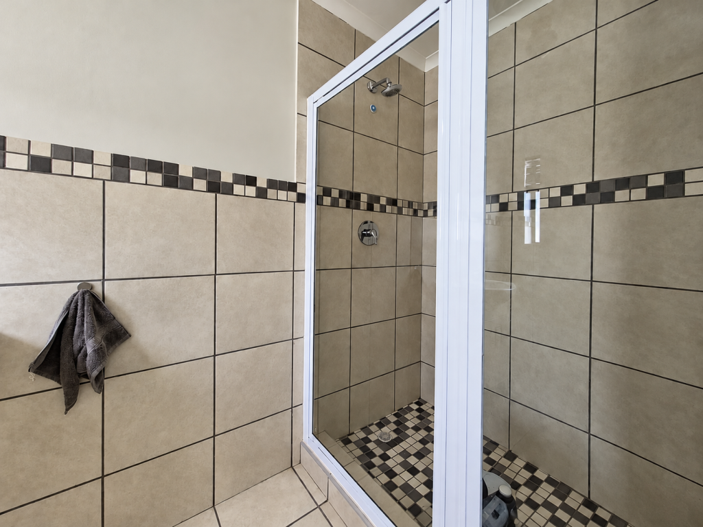 Modern Beige Tiled Shower with Mosaic Accents